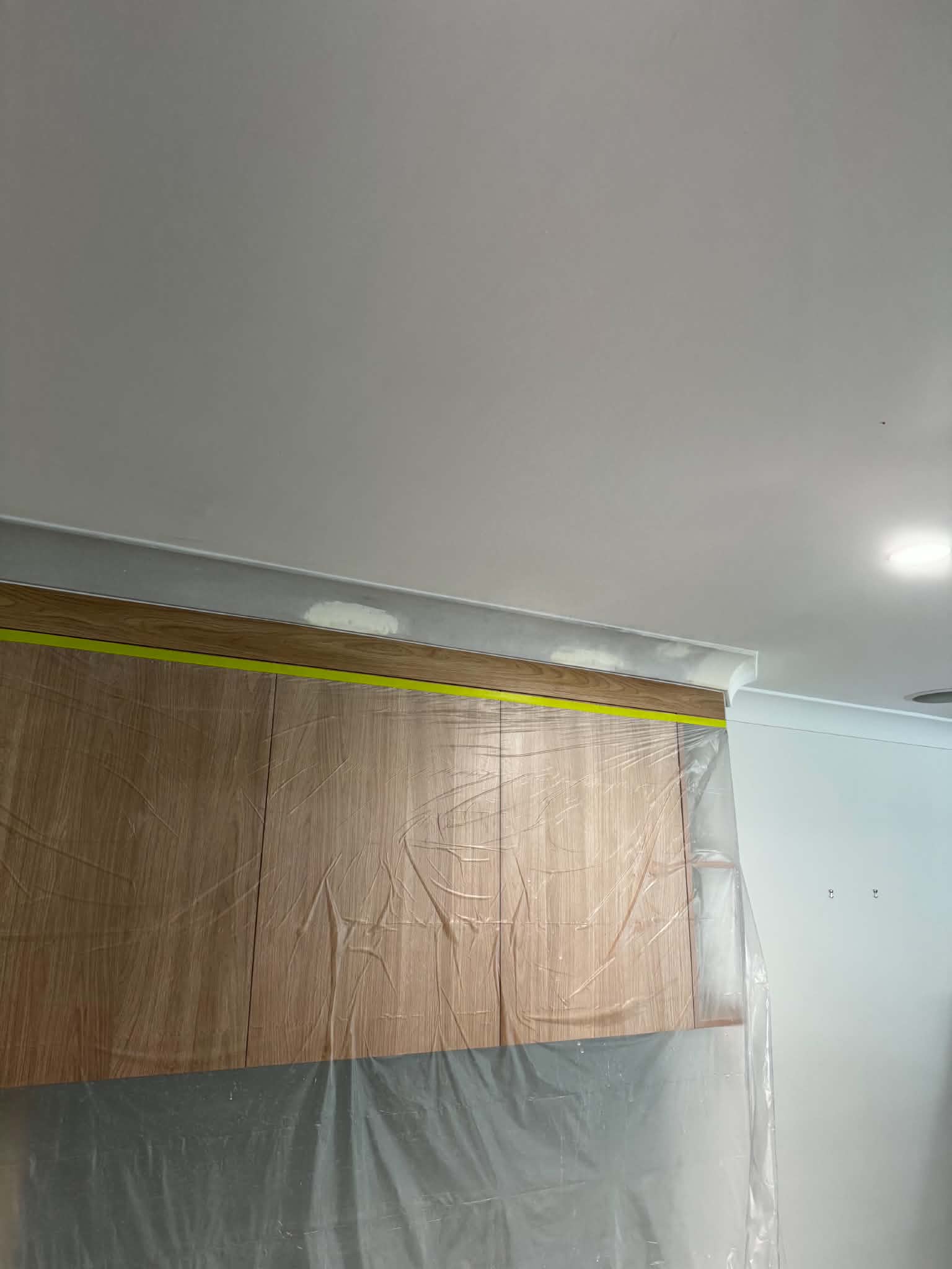 Protecting cupboards to get the cornices up — Plasterer work by A+S Poljak Plasterers in Sinnamon Park