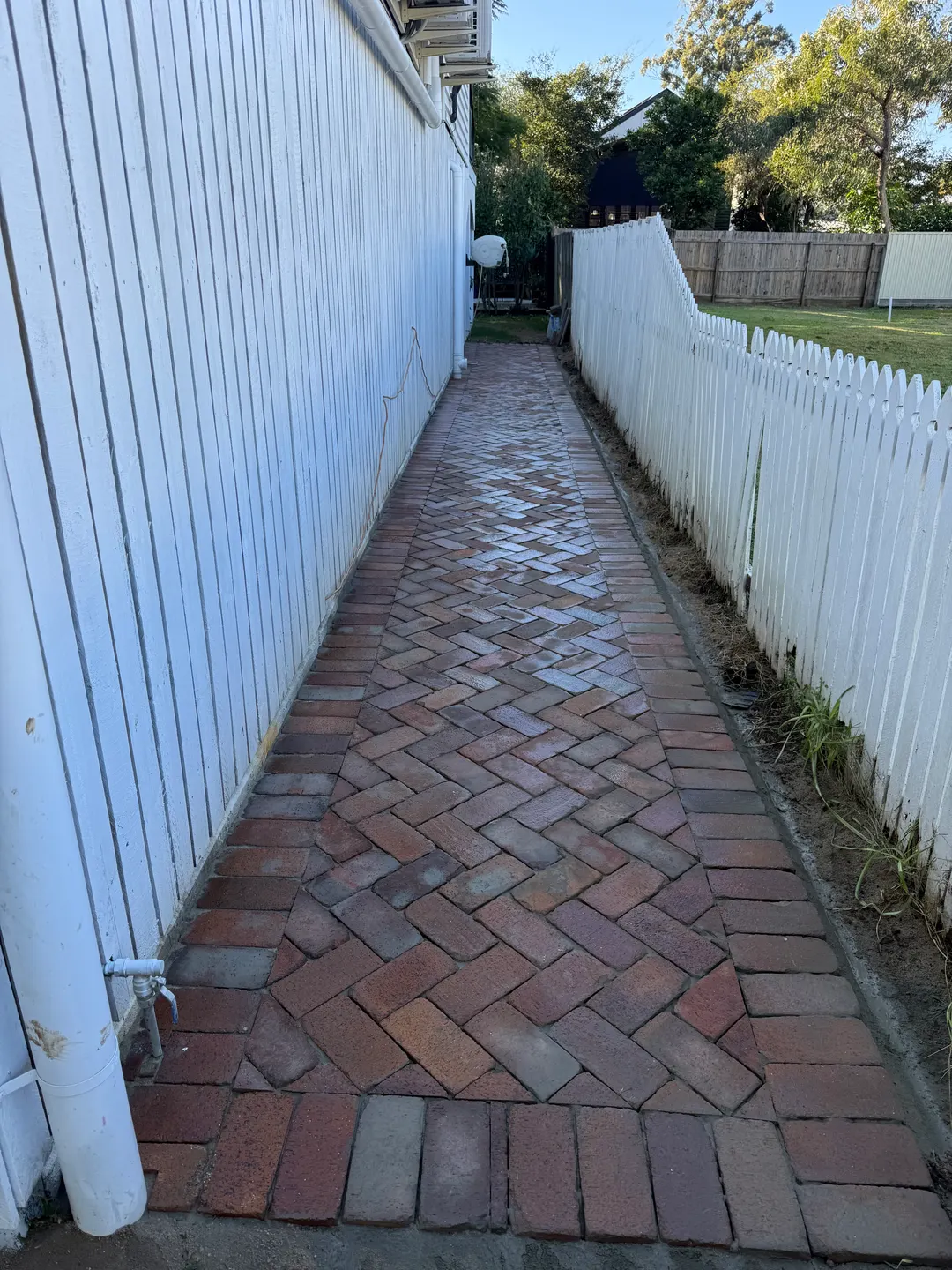 Before & after ...using old  pavers down side pathway — Concreting work by Unique Paving in Browns Plains